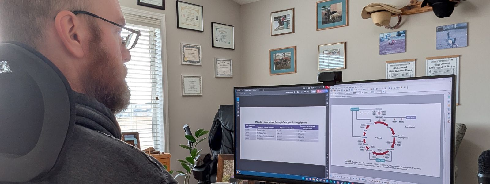 Online strength and fitness coach studying exercise physiology at his desk.